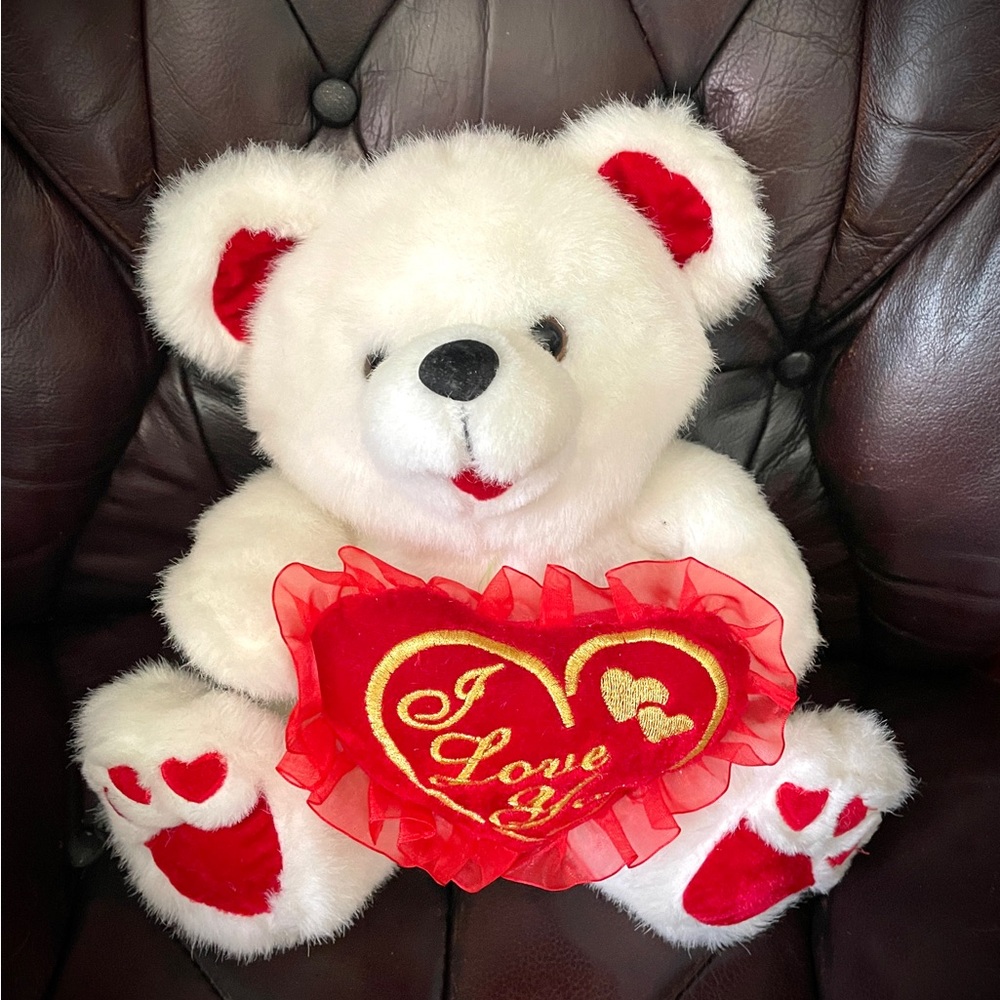 White faux fur bear toy, stuffed and with red heart attachment
